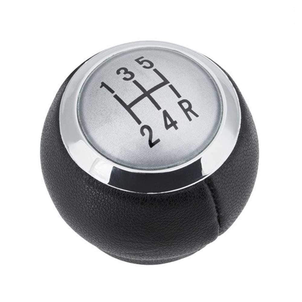 Fekete színű, bőrözött 5 sebességes Toyota váltógomb. Ezüst színű számlappal, króm számlapkerettel.