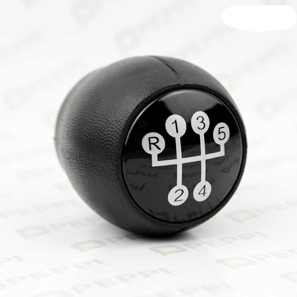 Fekete színű, 5 sebességes Opel váltógomb. Fekete színű üvegszámlappal, ezüst színű fokozatokkal.