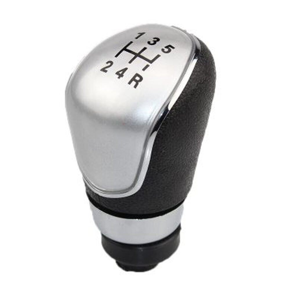 Fekete színű, 5 sebességes Ford váltógomb. Ezüst számlappal, króm számlapkerettel.