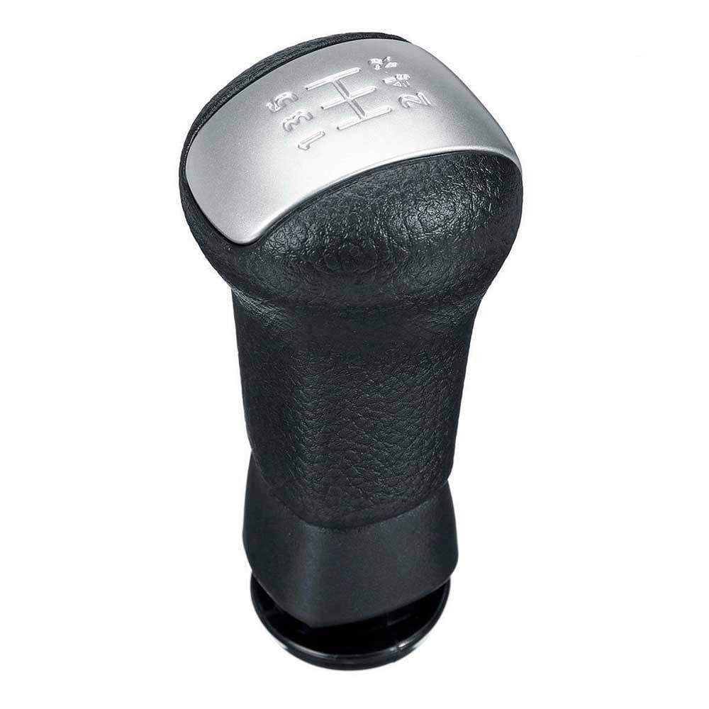 Fekete színű, bőrözött Nissan váltógomb. Ezüst színű számlappal.