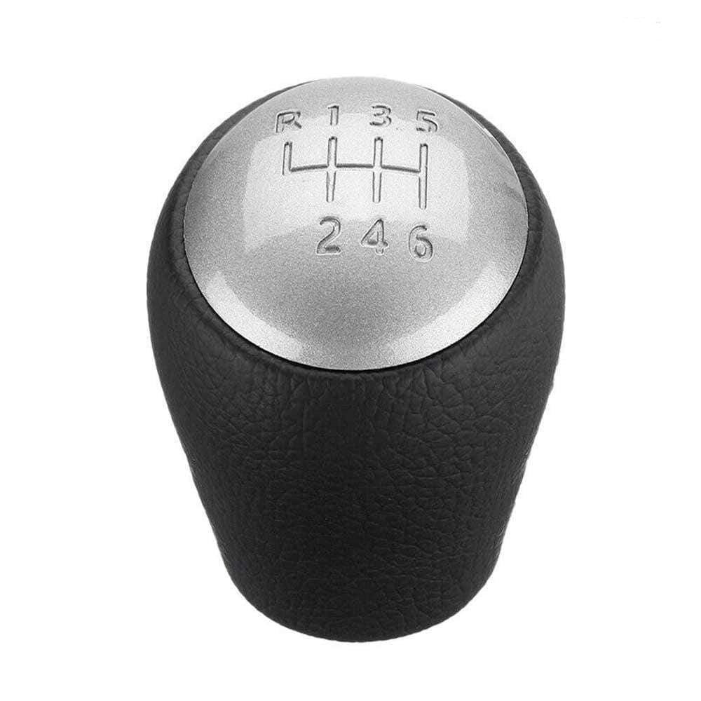 Fekete színű, bőrözött 6 sebességes Nissan váltógomb. Ezüst színű számlappal.