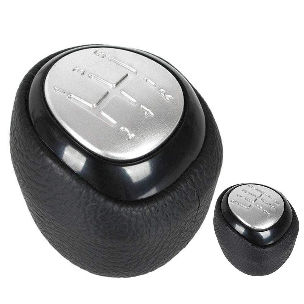 Fekete színű, 5 és 6 sebességes Saab váltógomb. Ezüst színű számlappal.